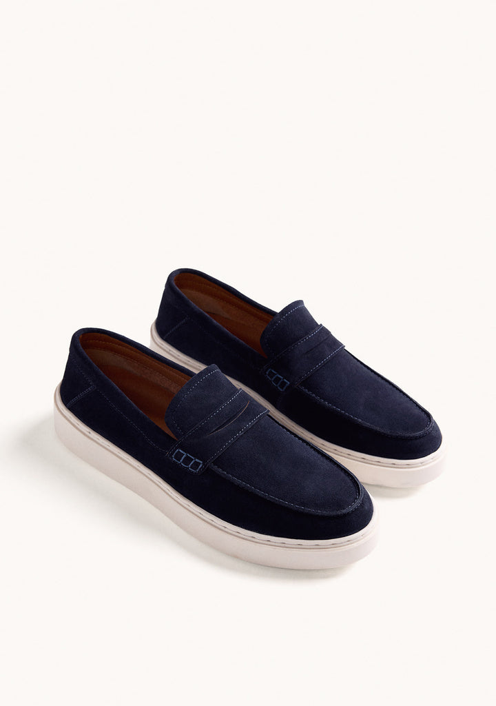 Navy penny loafers with moc toe stitching and light platform soles