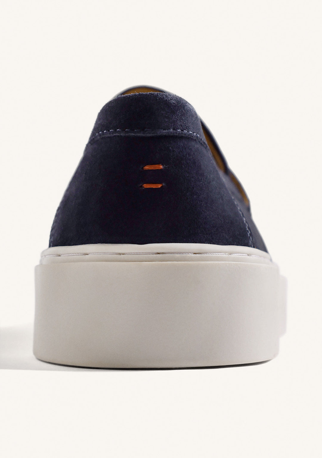 Navy penny loafers with moc toe stitching and light platform soles
