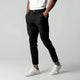 Men's slim tapered cropped chino pants shown in black and navy with side pockets and button closure