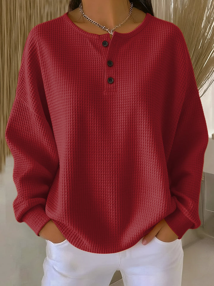 Women's waffle knit Henley top with long sleeves and button placket
