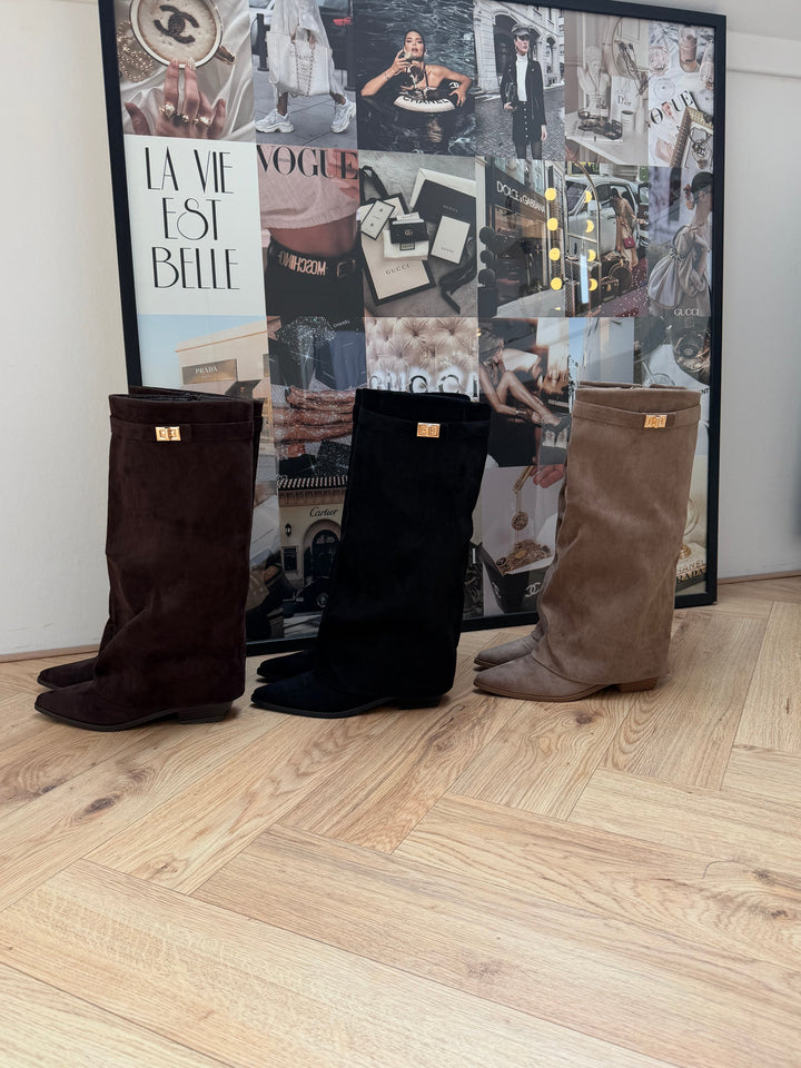 Women's brown knee-high boots with pointed toes, buckle straps and low block heels
