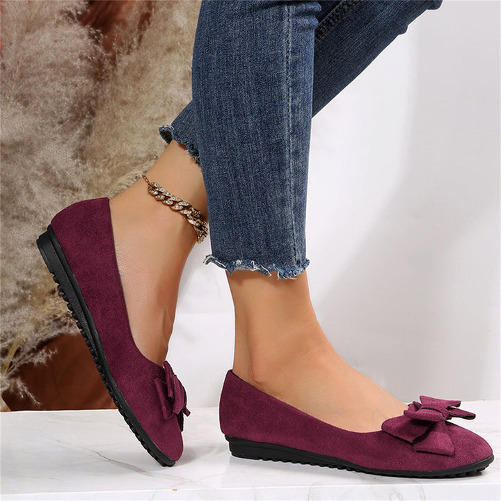 Bow detail flat loafers shown in black and dark green
