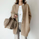 Women's long knitted cardigan with round neckline, long sleeves and button front