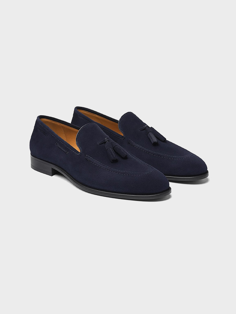Men's navy tassel loafers with almond toes and low heels