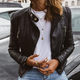 Women's black biker jacket with quilted sleeves and zip pockets