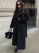 Women's long belted trench coat with lapel collar, buttons and full-length hem