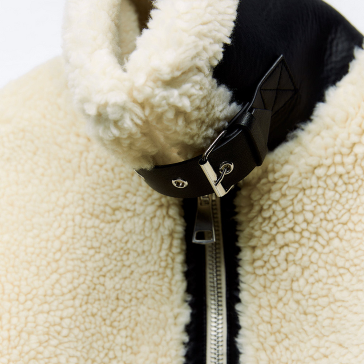 Women's white textured jacket with black trim and front zipper