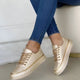 Women's low-cut sneakers with gold-tone trim and platform soles