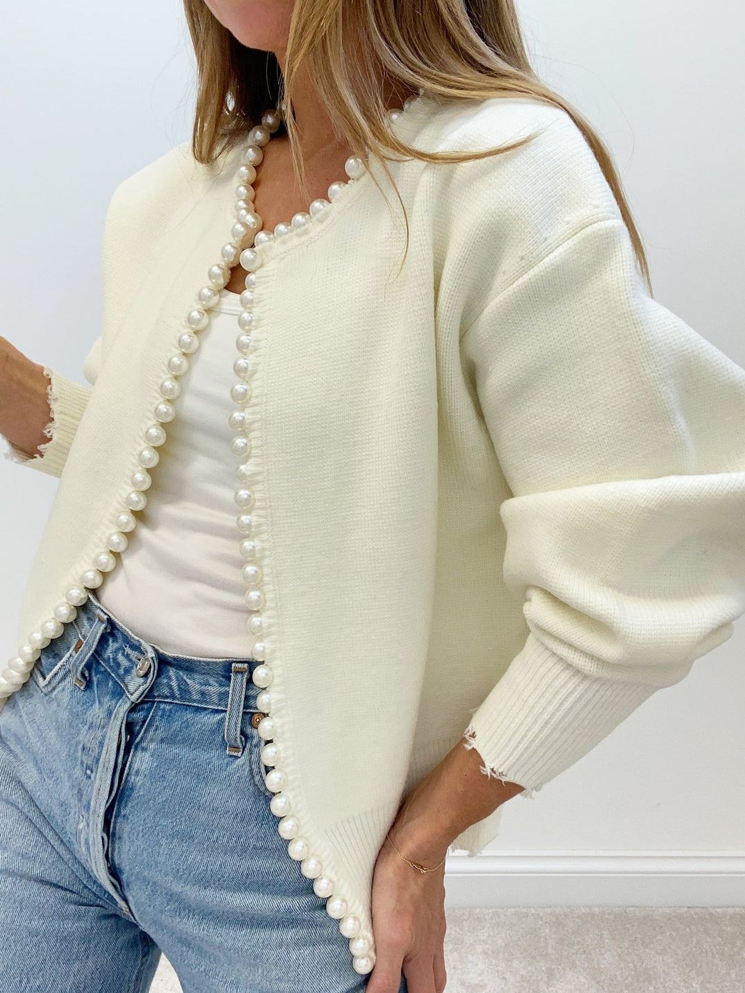 Women's open-front knit cardigan with pearl-style trim and long sleeves