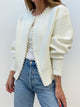 Women's open-front knit cardigan with pearl-style trim and long sleeves
