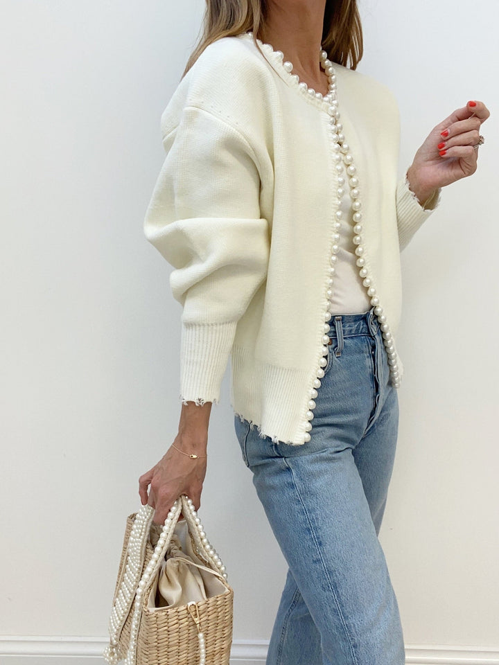 Women's open-front knit cardigan with pearl-style trim and long sleeves