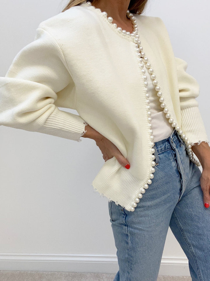 Women's open-front knit cardigan with pearl-style trim and long sleeves