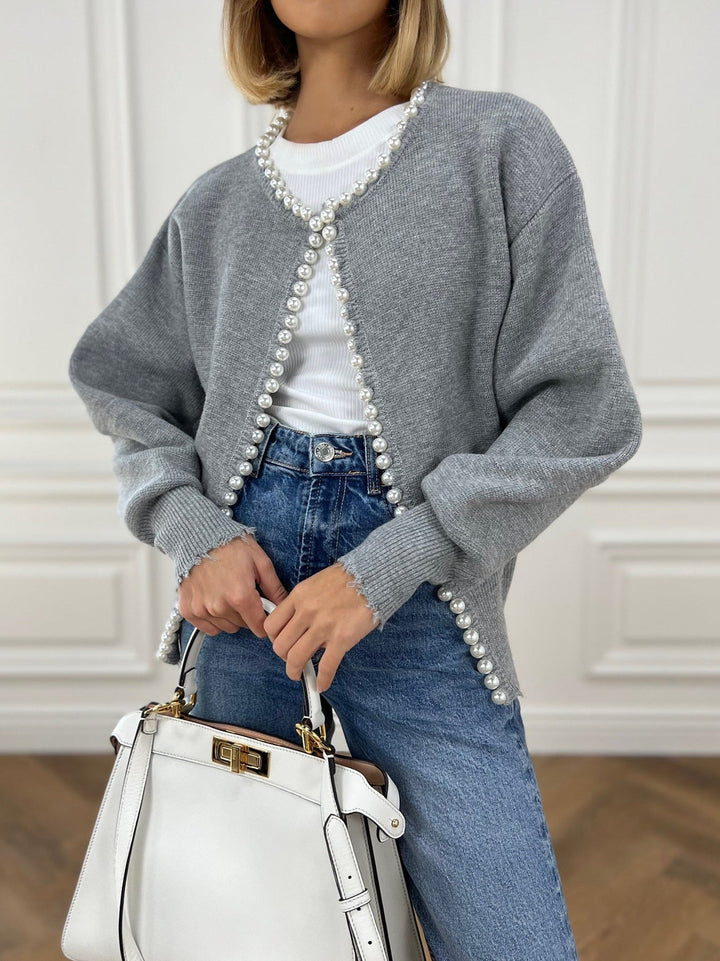 Women's open-front knit cardigan with pearl-style trim and long sleeves