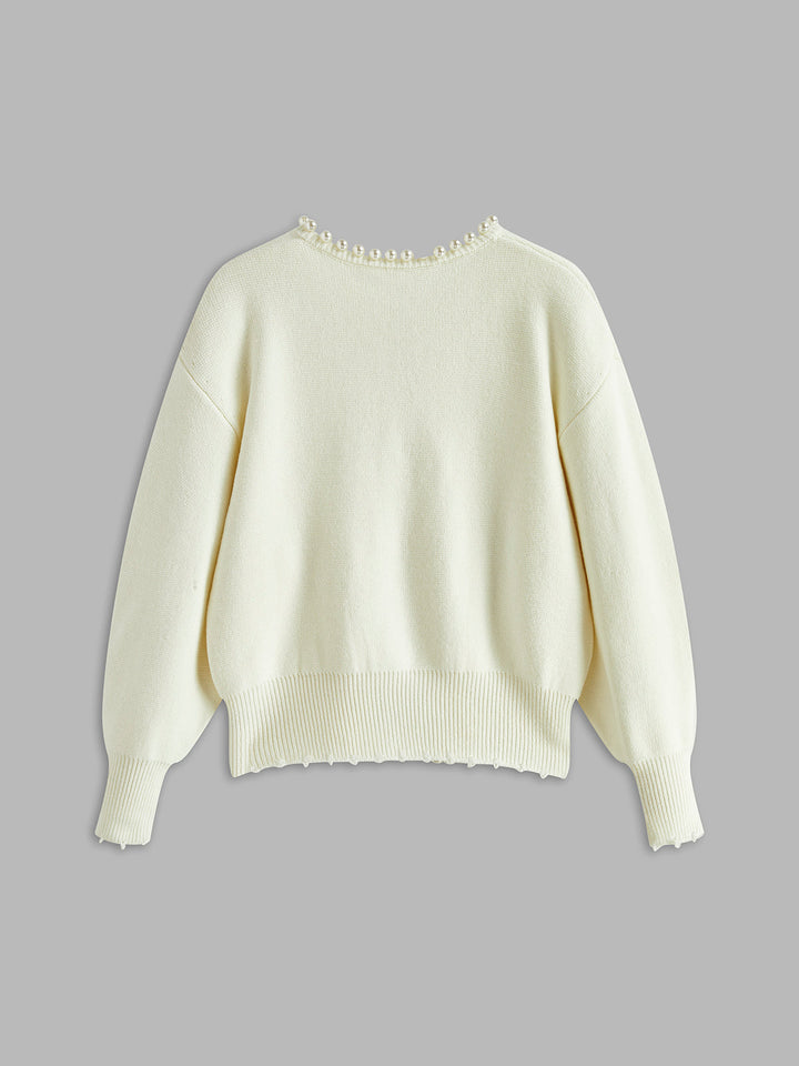 Women's open-front knit cardigan with pearl-style trim and long sleeves