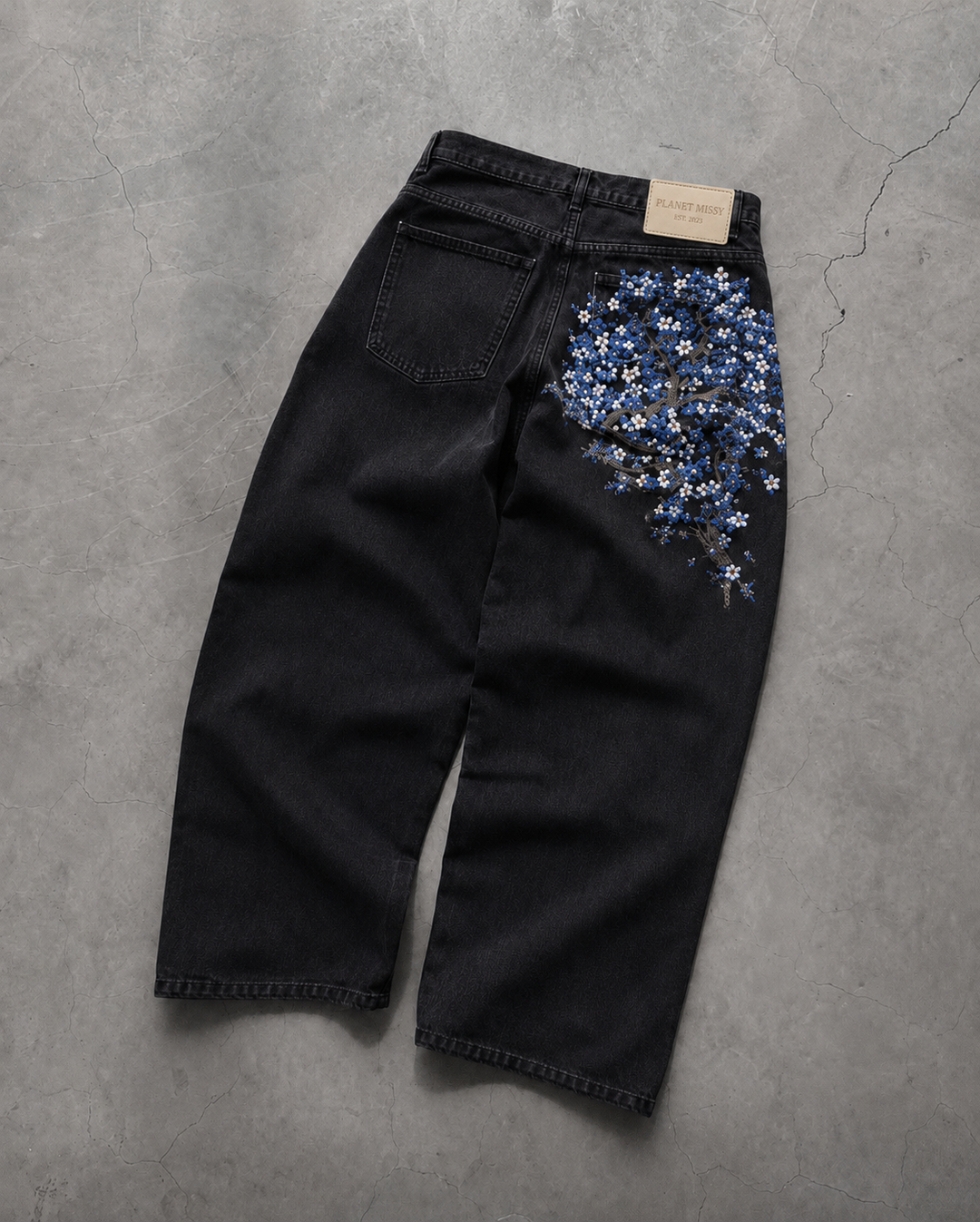 Women's black wide-leg jeans with blue floral embroidery