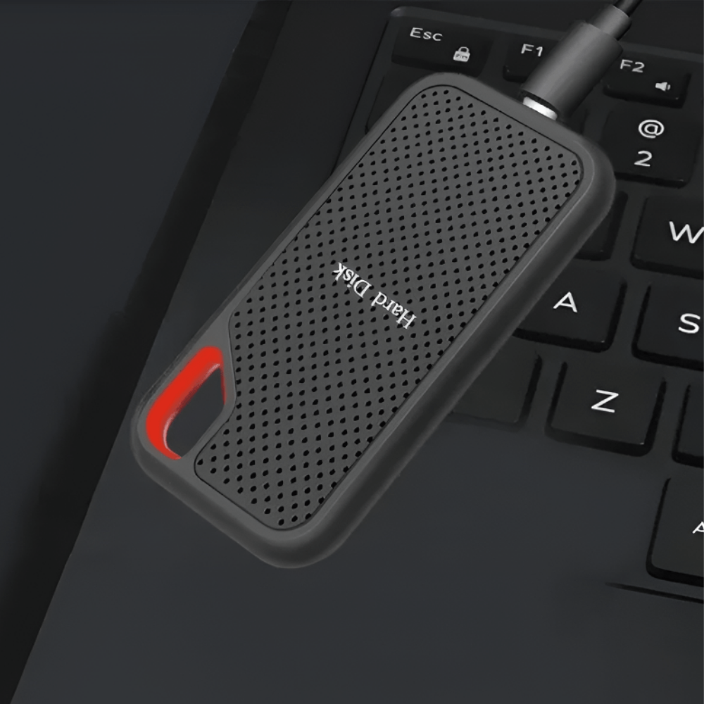 Black portable external SSD with red carry handle and USB cable