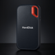Black portable external SSD with red carry handle and USB cable