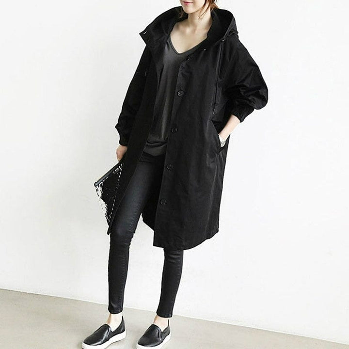 Women's hooded longline raincoat with button front and pockets