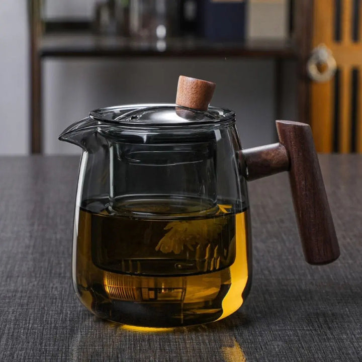 Clear glass teapot with central infuser and wood-effect handle