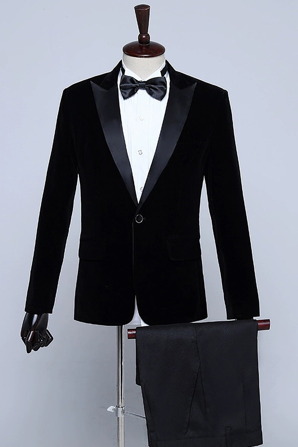 Men's velvet-textured tuxedo suit with peak lapels, bow tie and matching trousers