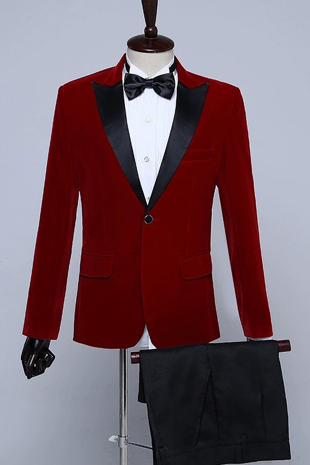 Men's velvet-textured tuxedo suit with peak lapels, bow tie and matching trousers