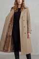 Women's long double-breasted trench coat shown open with brown faux fur lining
