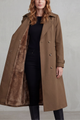 Women's long double-breasted trench coat shown open with brown faux fur lining