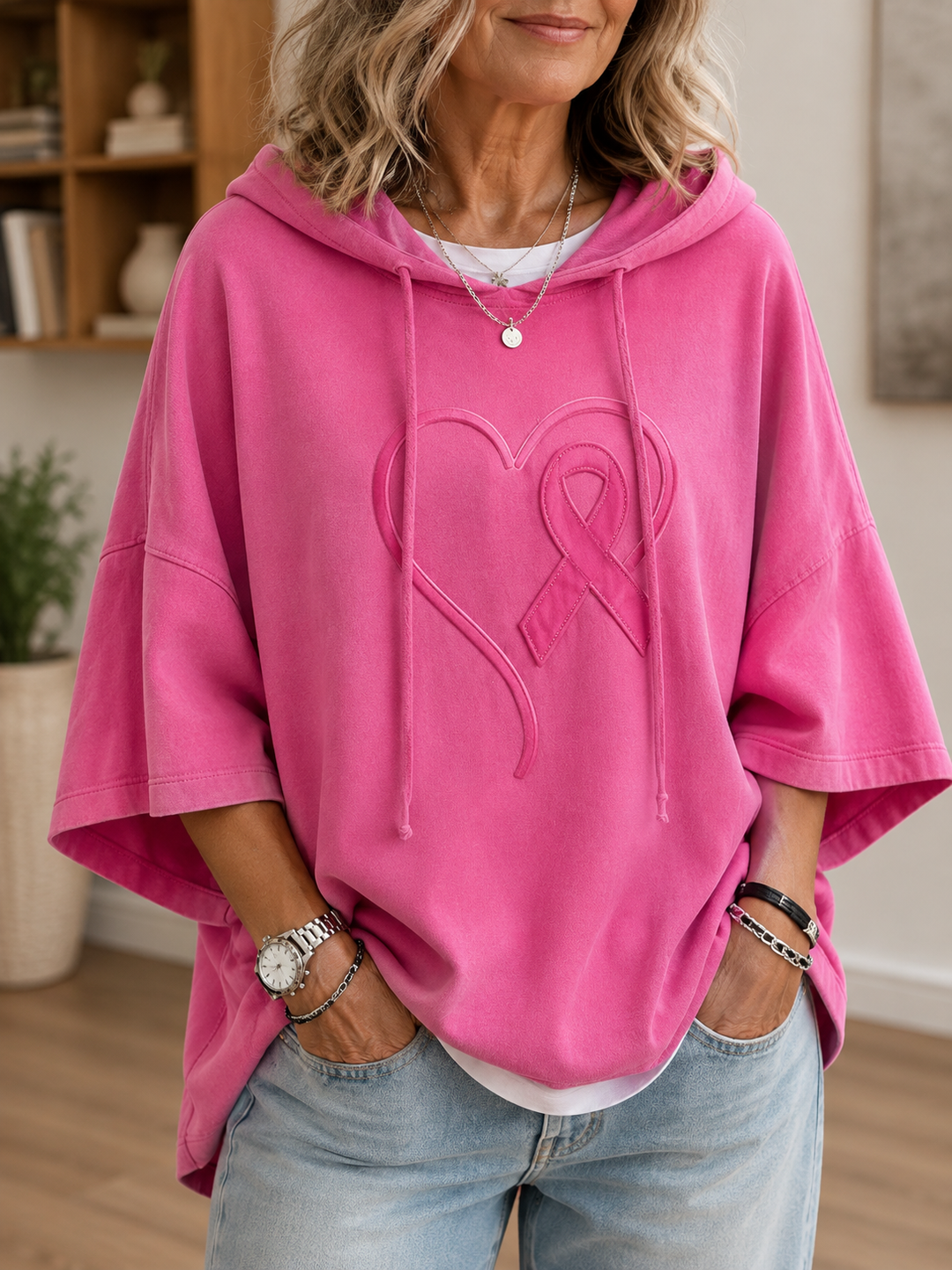 Women's pink hooded pullover with raised awareness ribbon motif