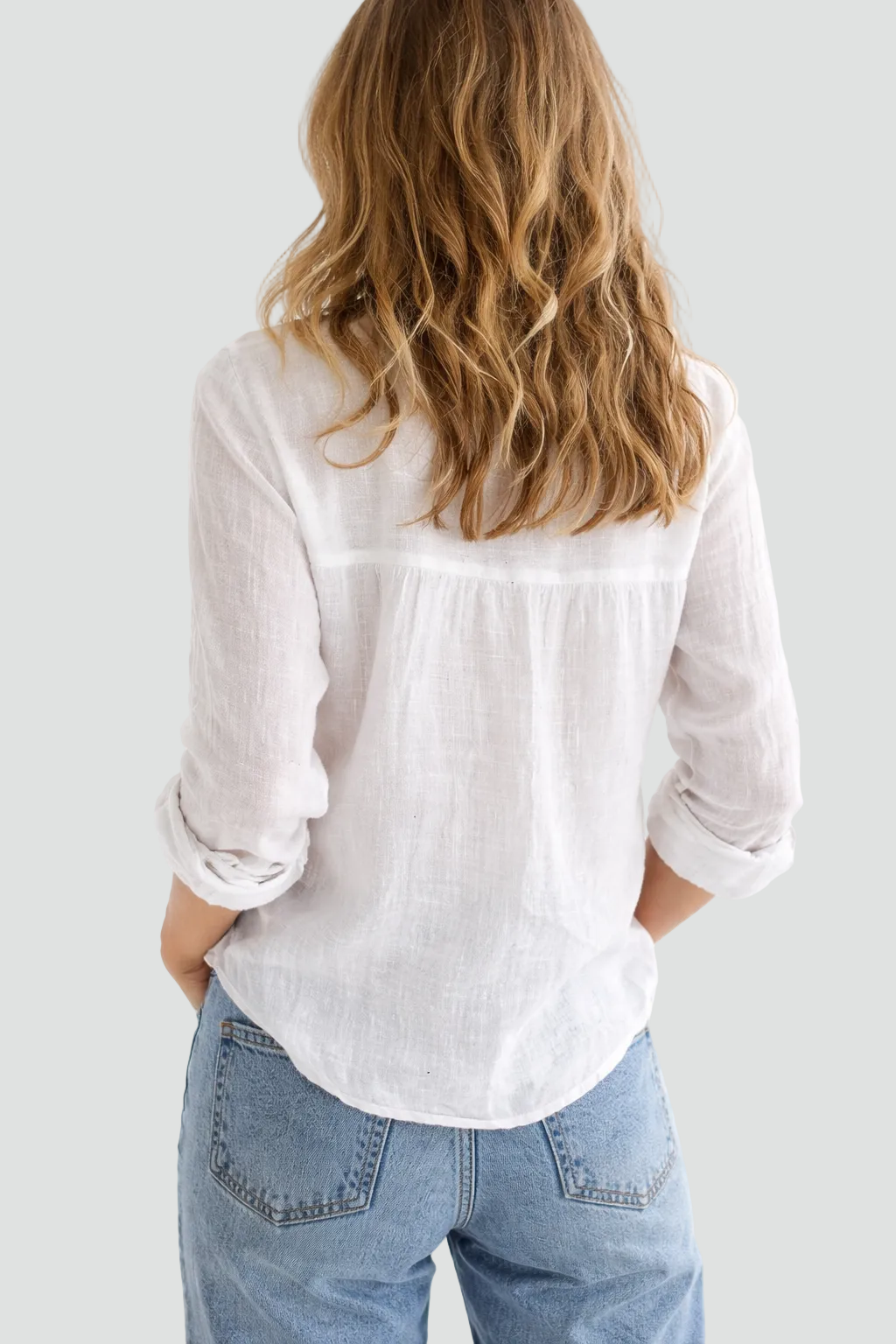 Women's long-sleeve button-up blouse with V-neck and rolled sleeves