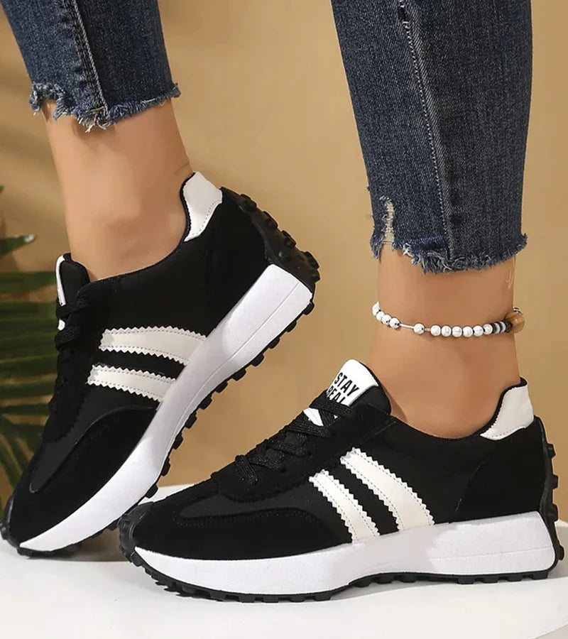 Women's low-top lace-up sneakers with contrast side stripes and raised sole