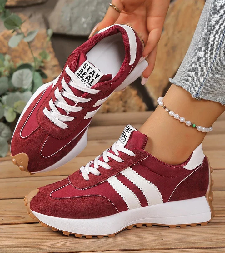 Women's low-top lace-up sneakers with contrast side stripes and raised sole