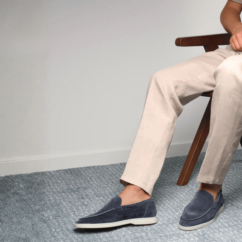 Men's grey slip-on loafers with moc toe and flat light-coloured soles