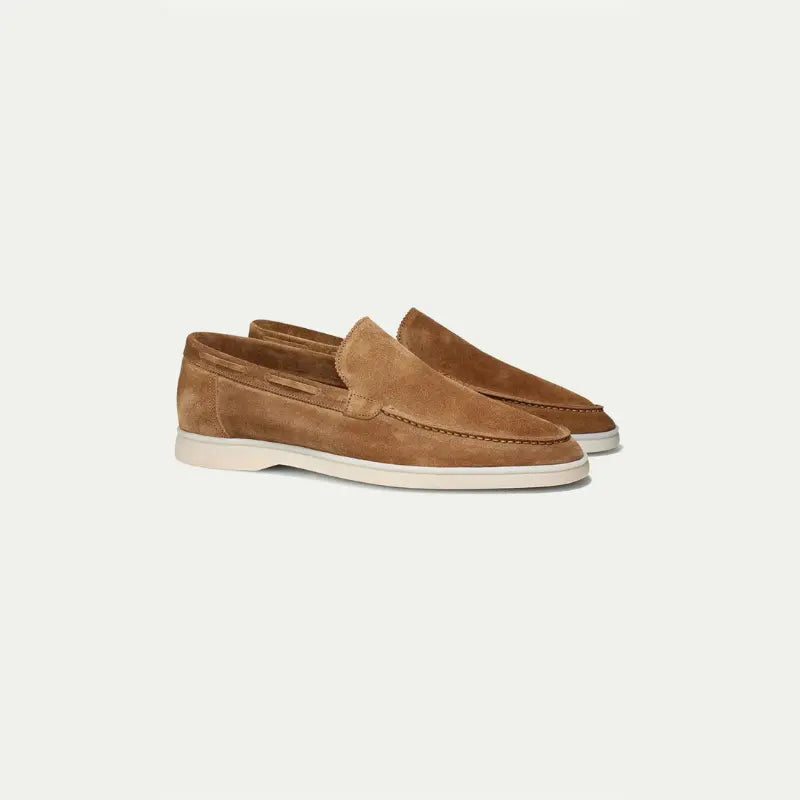 Men's brown slip-on loafers with moc toe stitching and white soles