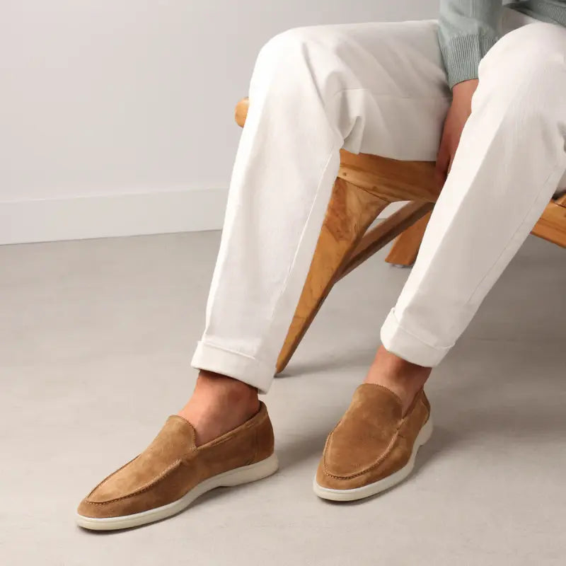 Men's brown slip-on loafers with moc toe stitching and white soles