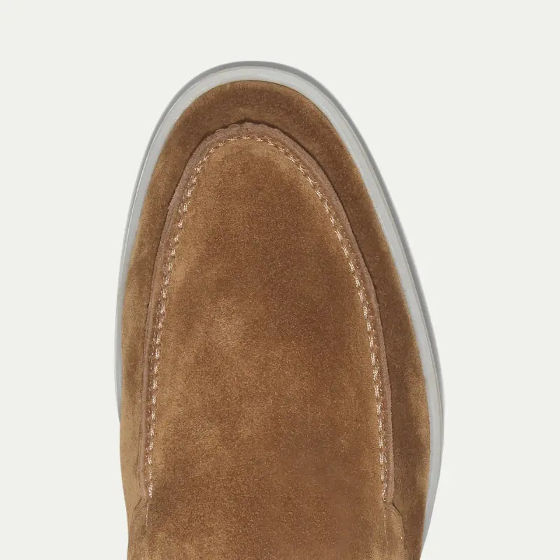 Men's brown slip-on loafers with moc toe stitching and white soles