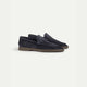 Men's navy penny loafers with almond toes and flat brown soles