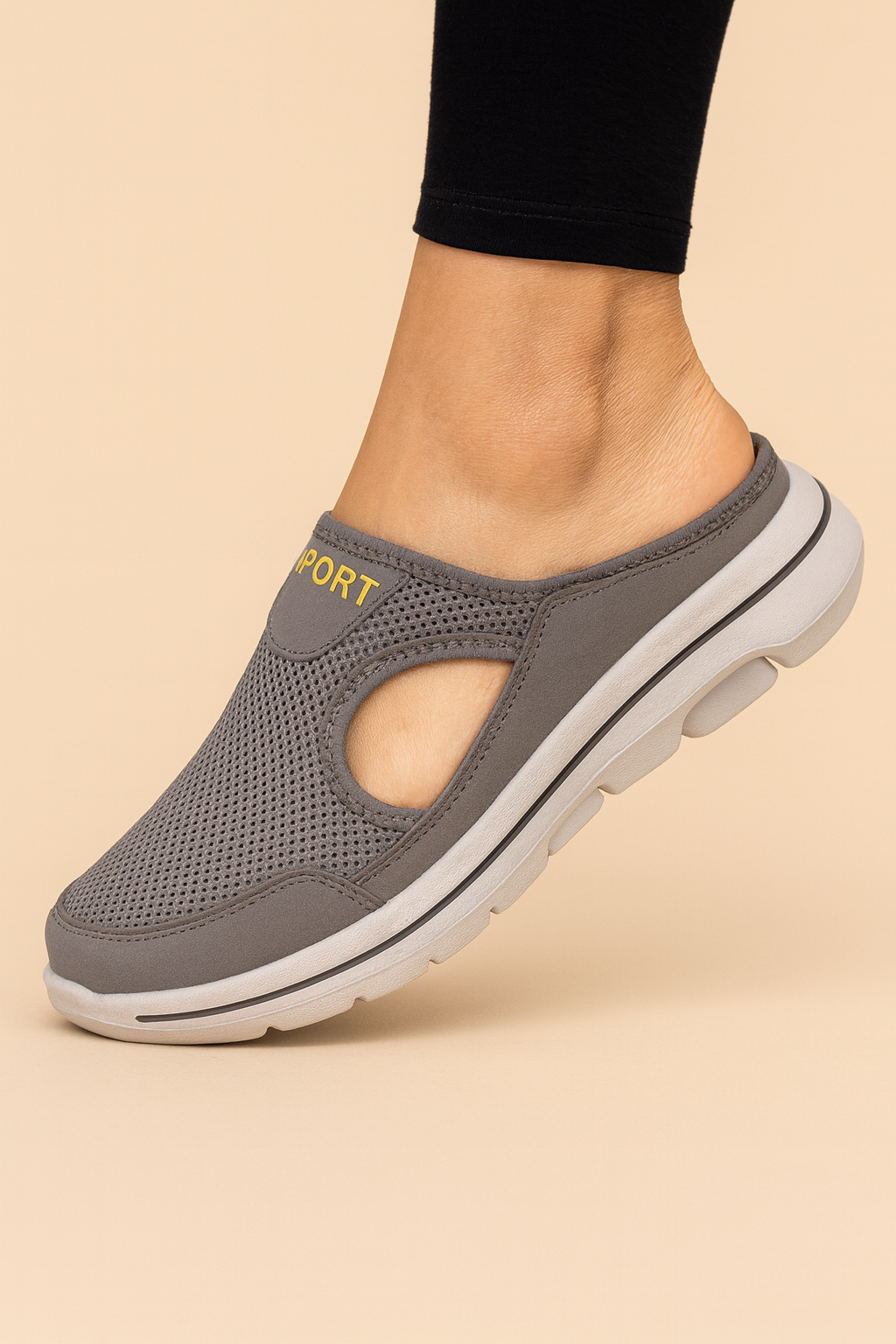 Women's orthopaedic slippers in black mesh and white sole, worn on bare feet