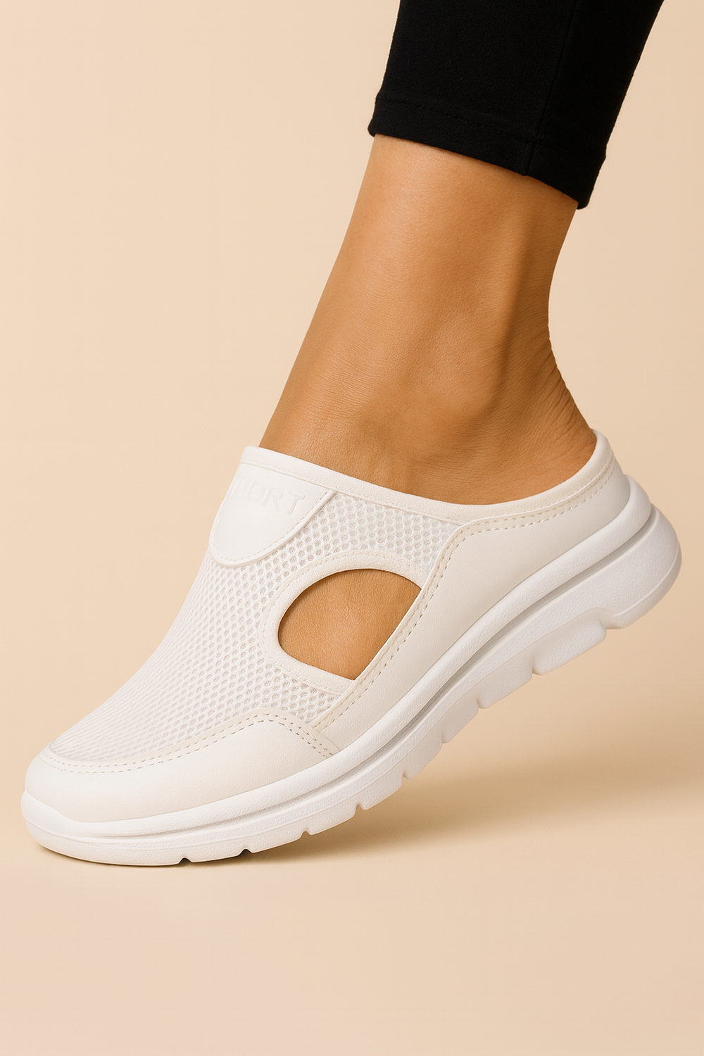 Women's orthopaedic slippers in black mesh and white sole, worn on bare feet