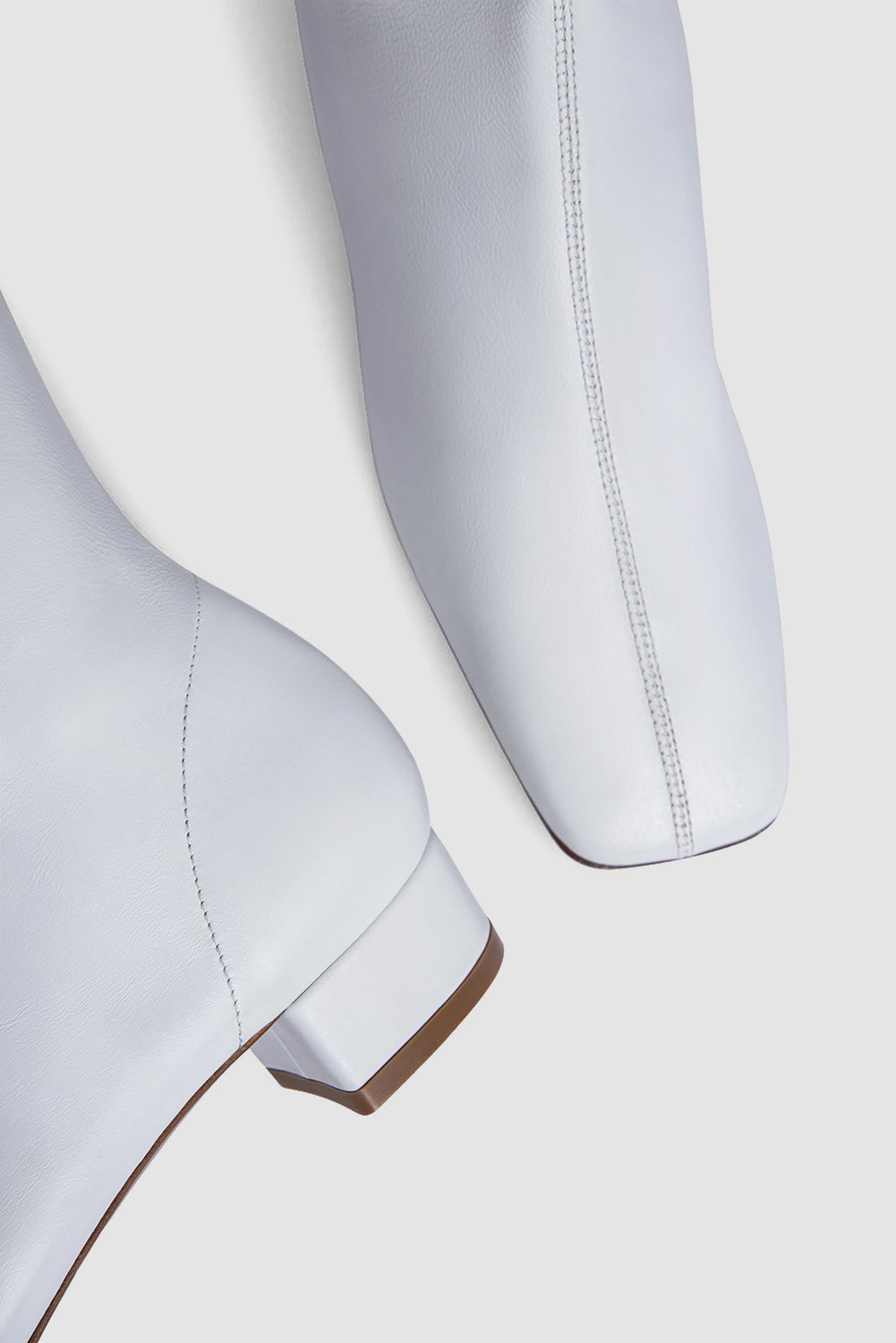 White women's knee-high boots with square toes and low block heels