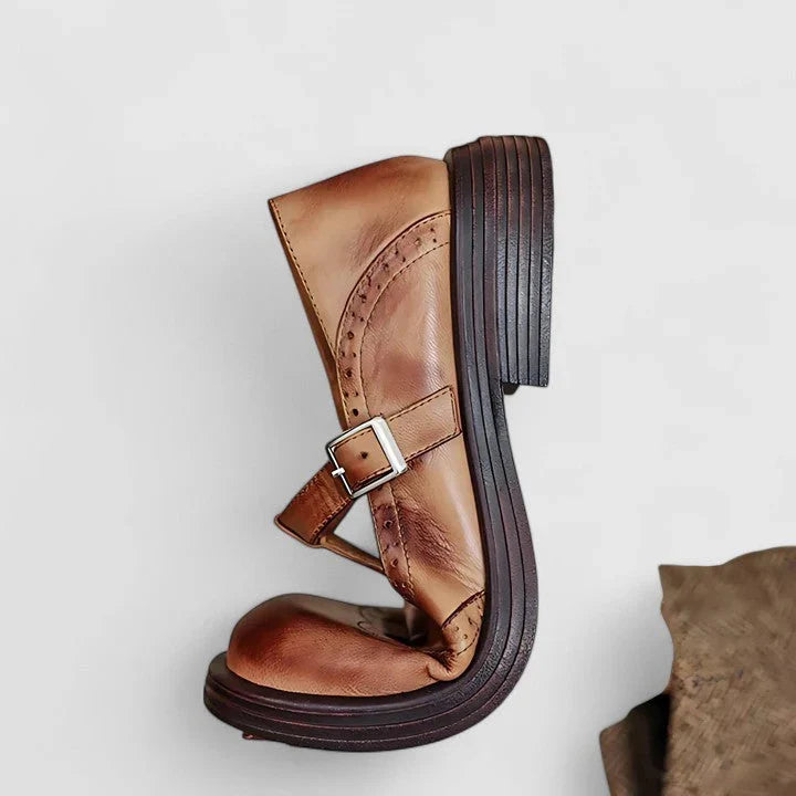 Women's brown and black brogue Mary Jane flats with buckle straps and low heels