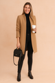 Women's minimalist knee-length coat with high collar and long sleeves