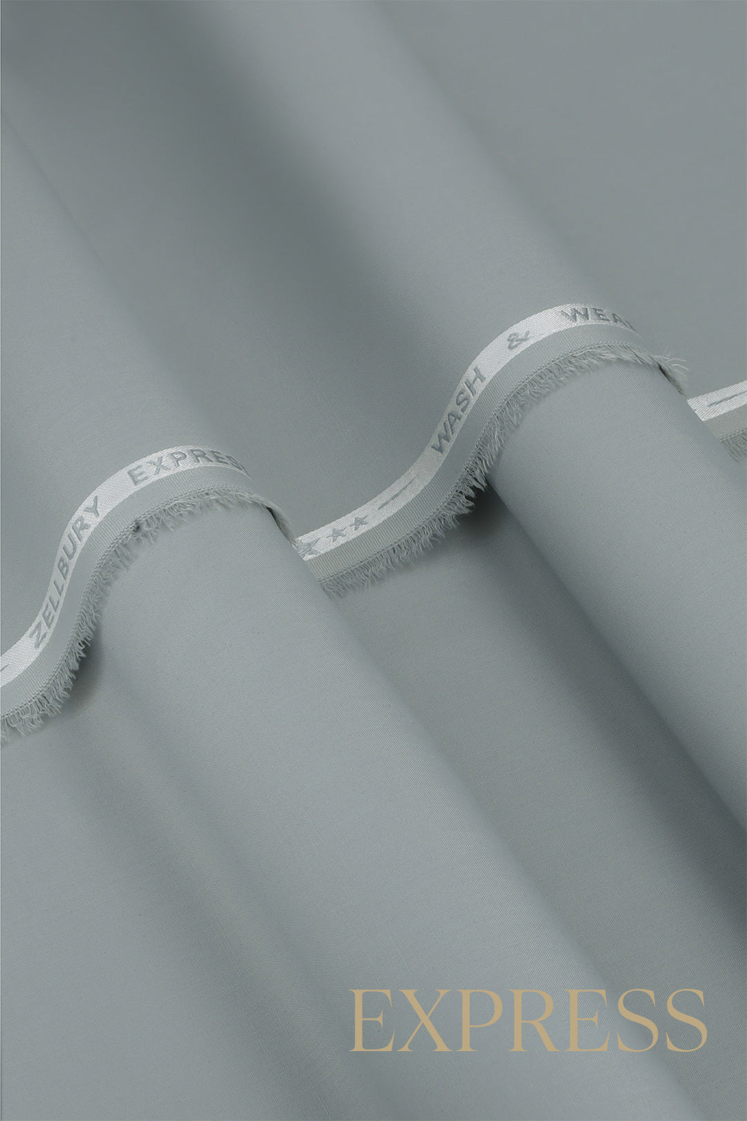 Close-up of solid wash and wear suit fabric with blue branded trim