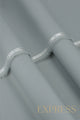 Close-up of solid wash and wear suit fabric with blue branded trim