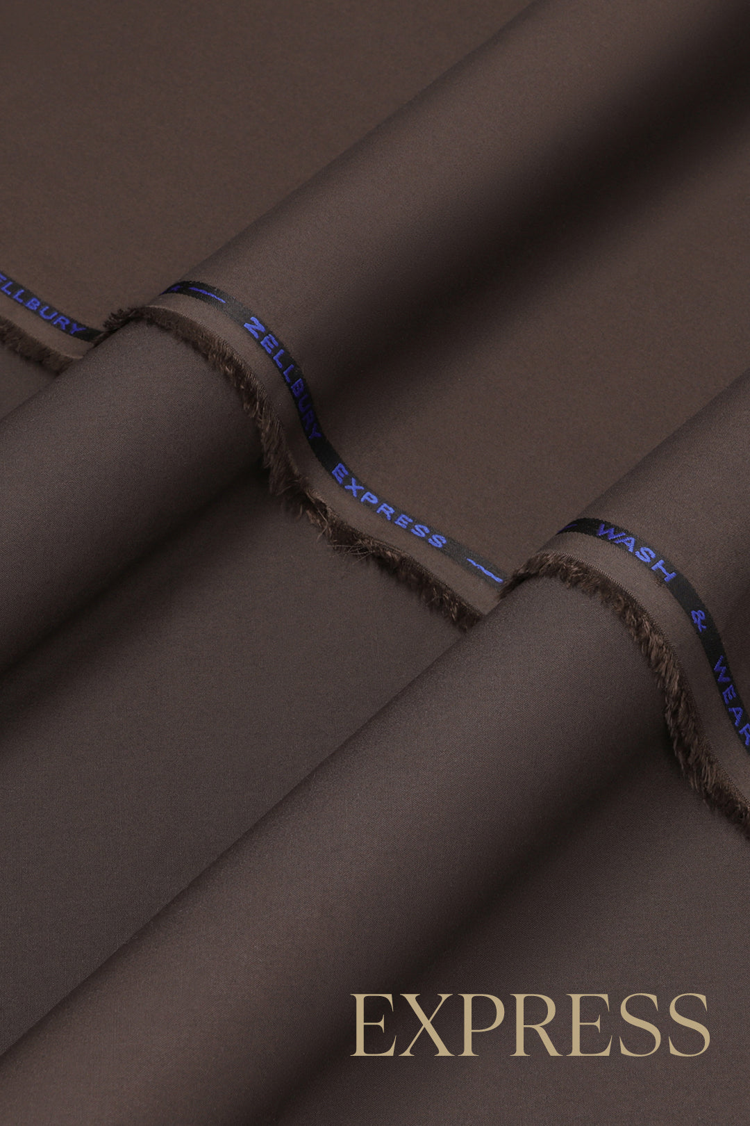 Close-up of solid wash and wear suit fabric with blue branded trim