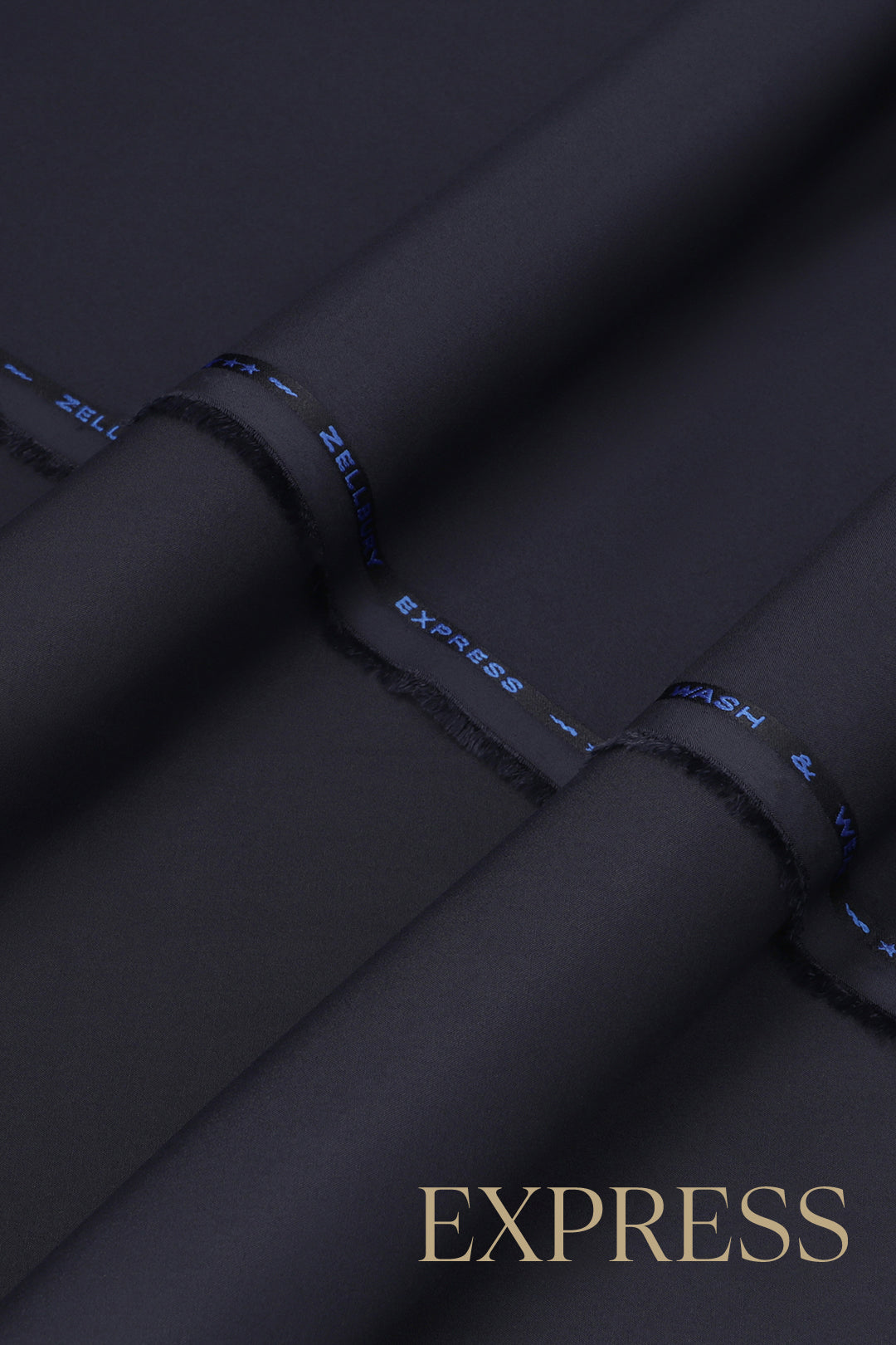 Close-up of solid wash and wear suit fabric with blue branded trim