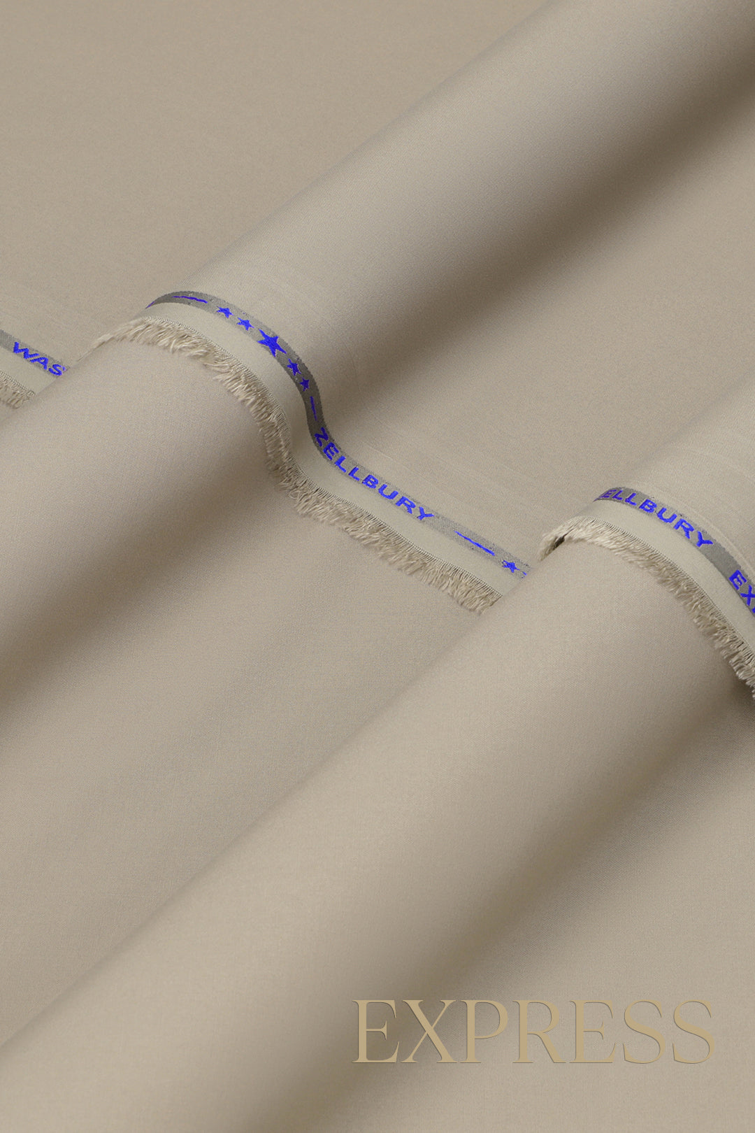 Close-up of solid wash and wear suit fabric with blue branded trim
