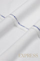 Close-up of solid wash and wear suit fabric with blue branded trim