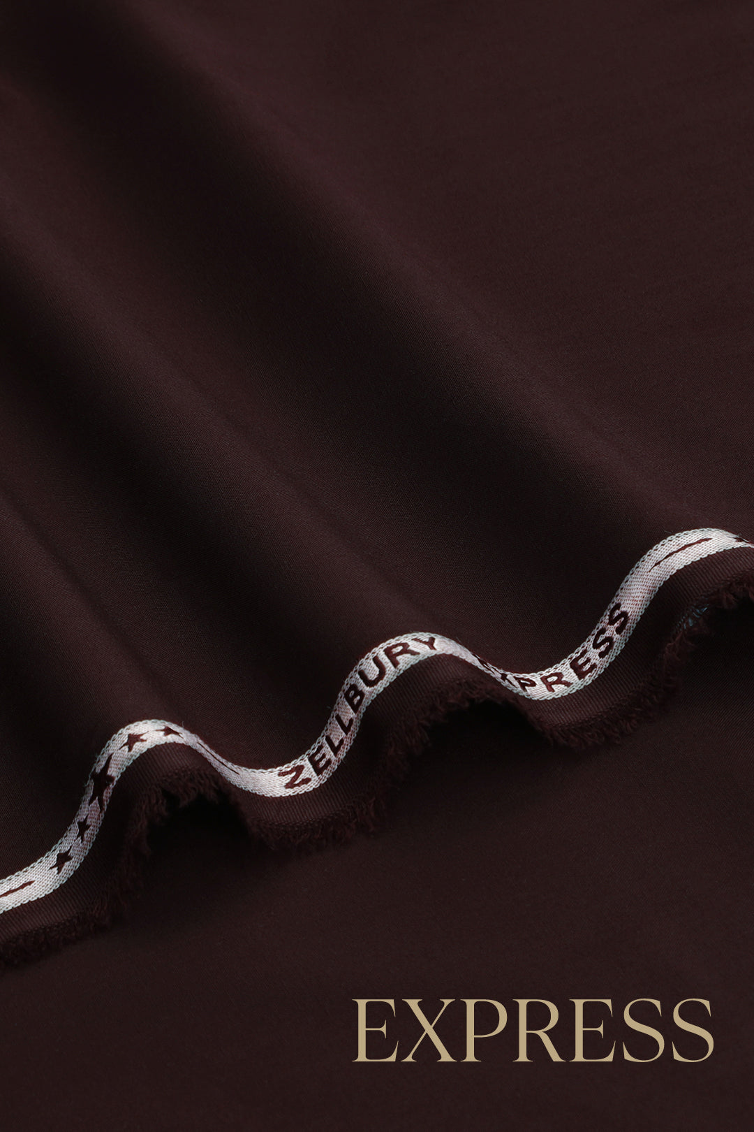 Close-up of solid wash and wear suit fabric with blue branded trim