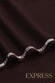 Close-up of solid wash and wear suit fabric with blue branded trim