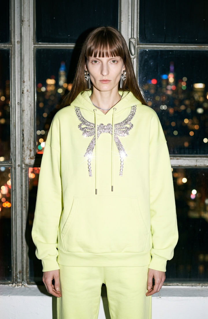 Black pullover hoodie with embellished wing detail, hood, drawstrings and front pouch pocket